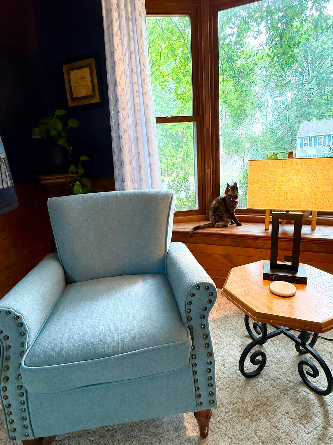A cozy bay window sitting area at Serenity Co-Living Residence