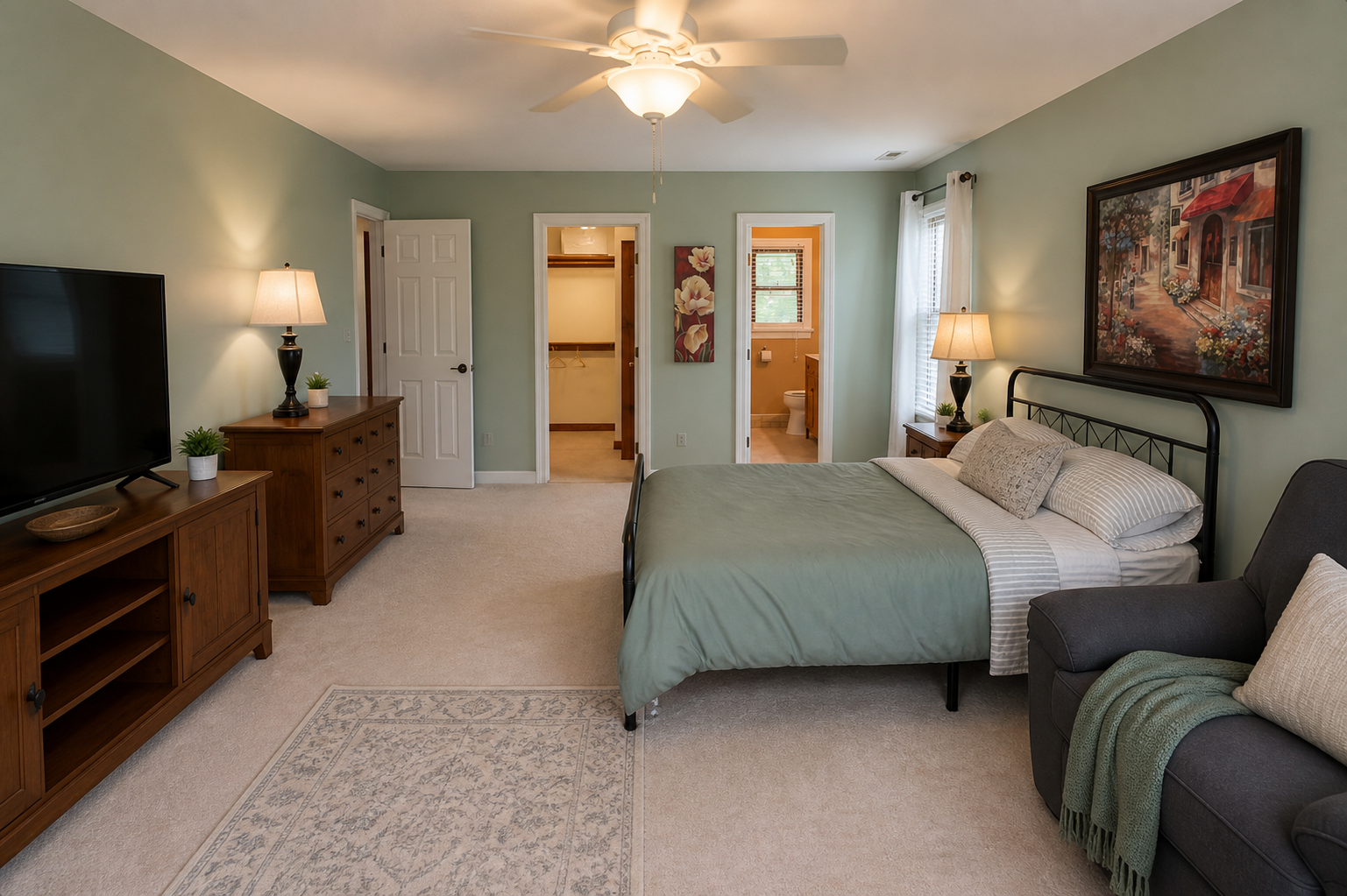 A private suite with calm green walls and warm furnishings