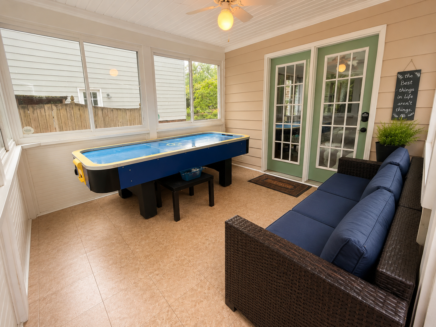 A sunroom with seating and recreation space